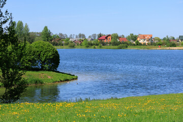 Buildings and houses standing on the shore of a lake, river or sea. 