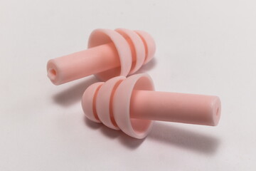 Silicone ear plugs for human ears on white background