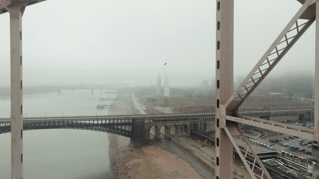 Flying through truss of Martin Luther King Bridge, view of foggy of St. Louis.