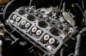 Cylinder head of a car engine. Sixteen valves. Repairing car. Auto service.