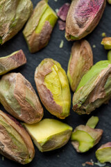 Crispy delicious pistachios with salt on the table