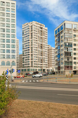 Fototapeta na wymiar City view on a sunny day. Modern houses against the blue sky.