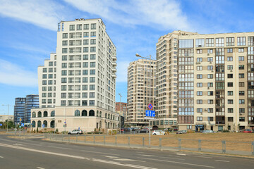 City view on a sunny day. Modern houses against the blue sky.