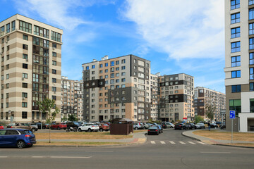 Obraz premium City view on a sunny day. Modern houses against the blue sky.