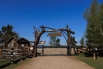Wooden gate, door and fence in rustic style on a summer day