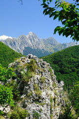 Tuscany mountains. Panorama of mountains. Pizzo d'Uccello, Monte Sagro and the Apuan Alps between green woods and blue sky. Apuan Alps, Tuscany, Italy. 