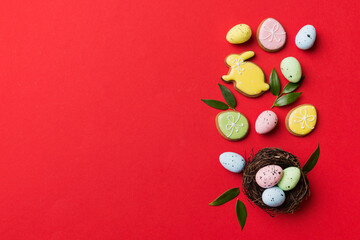 Colorful easter eggs in nest on table background with copy space top view