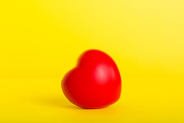 gift box with red bow and red heart on colored background. Perspective view. Flat lay