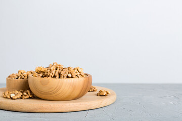 Fresh healthy walnuts in bowl on colored table background. Top view Healthy eating bertholletia concept. Super foods