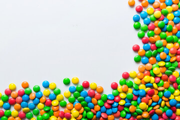 Mixed collection of colorful candy, on colored background. Flat lay, top view. frame of colorful chocolate coated candy