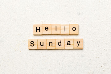 hello sunday word written on wood block. hello sunday text on cement table for your desing, concept