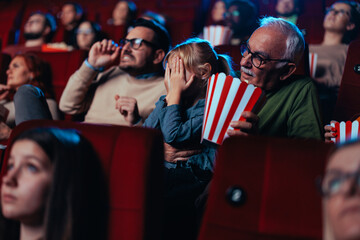 Scared child in movie theater.