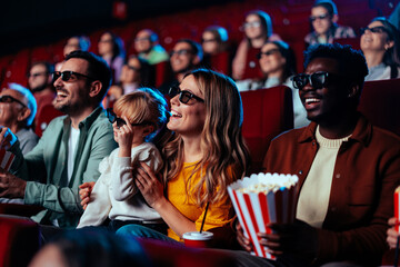 Happy audience in 3D movie theater. © bernardbodo