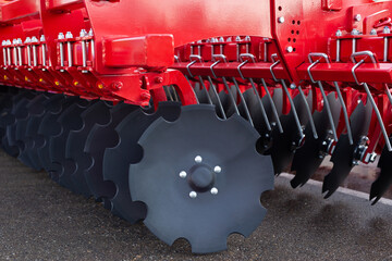 Trailed in-line disc harrow at an agricultural exhibition.