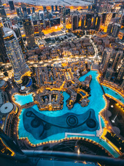 Aerial view of Downtown Dubai with roads, Dubai Mall and the fountain at sunrise, from Burj Khalifa observatory deck in United Arab Emirates