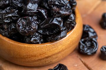 Black pile of prunes from a large number of ripe plums