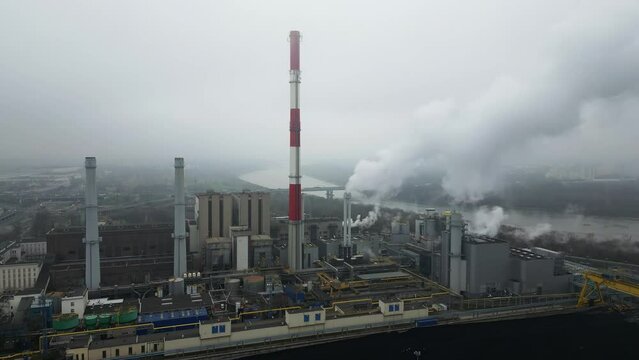 Environmental issues, energy extraction from coal, termal power station, view from height of the pipes in the smog, aerial view.