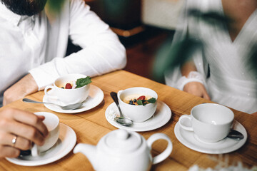 Obraz na płótnie Canvas Starting the Day Right: Couple Enjoys Delicious Breakfast at Cozy Cafe