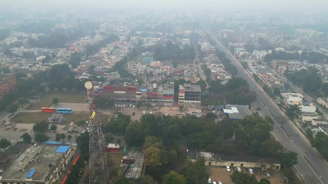 early morning Punjab city bird eye view Mohali India drone shot winter fog