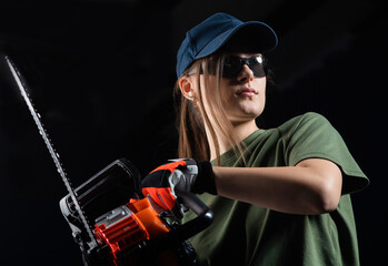  Girl with a chain saw on dark background