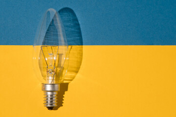 An old glass electric light bulb with a tungsten filament. The concept of electricity consumption...
