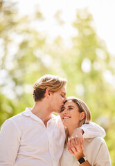 Fototapeta premium Hug, love and couple kiss for happy, quality time and bonding on weekend, vacation and holiday. Summer, dating mockup and young man and woman hugging, kissing and romantic embrace in nature park