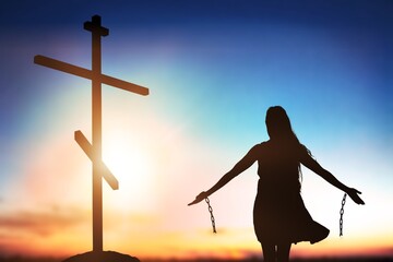 Silhouette of woman break chains with Holy Cross on background