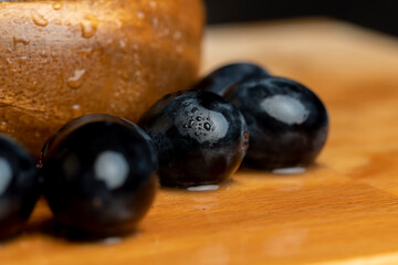 Wet black and blue grapes on the table