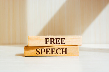 Wooden blocks with words 'Free Speech'.