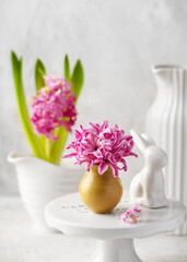 Spring floristic arrangement with pink hyacinth flowers in a small vase for Eastern. Pastel vintage style. Selective focus. Copy space.