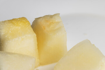 Ripe yellow melon cut into pieces and portions