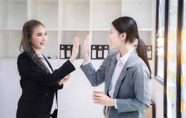Happy creative business people are motivated, giving high five and celebration successful deal. Cooperation Meeting Partnership Career growth Team building Successful business.