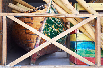 Old wooden boat in warehouse