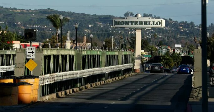 Montebello, California, USA - February 2, 2023: Eastbound traffic passes down Whittier Boulevard by a Montebello Welcome sign.