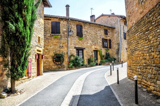 Wandering through the charming streets of Oingt, belonging to the The Most Beautiful Villages of France. 
Oingt, Bois-d'Oingt, Auvergne-Rhône-Alpes, France, Europe. Beaujolais golden stones

