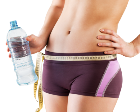 Slim young woman measuring her thin waist with a tape measure, close up