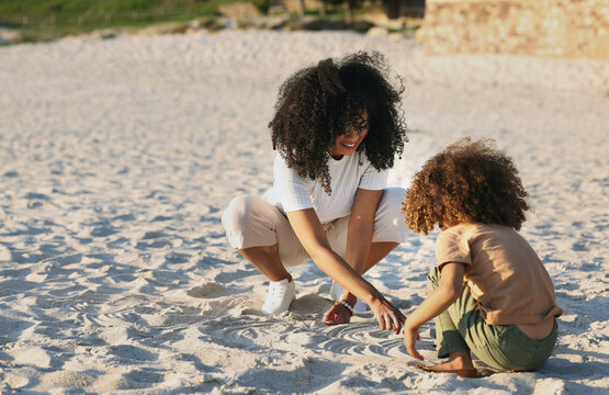 Black family at the beach, mother and child play in sand on summer holiday, freedom and travel with nature outdoor. Fun together, vacation and carefree with happiness, woman and girl in Jamaica