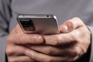 Close up of a man using mobile smart phone