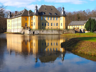 Fototapeta premium Romantic yellow water castle Schloss Dyck in Juechen in Germany