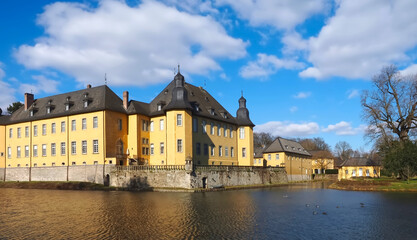 Fototapeta premium Romantic yellow water castle Schloss Dyck in Juechen in Germany