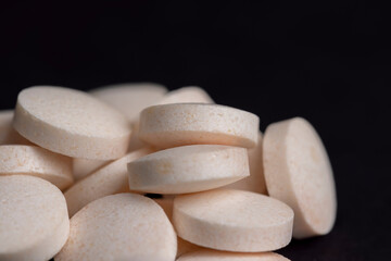 White and yellow medical medicines on a black background