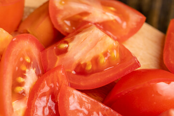 Ripe red tomatoes on a wooden chopping board