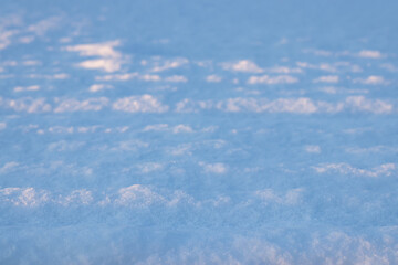Snow, snow cover in the rays of sunset with defocus light, with focus and defocus zones