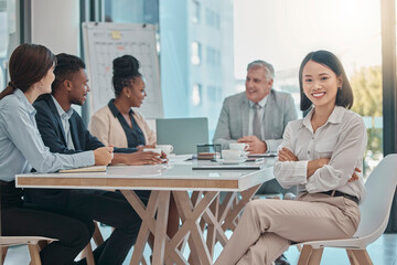 Asian woman, portrait and arms crossed for leadership in meeting, management or planning at the office. Happy female leader or manager with smile sitting at conference table for team project plan