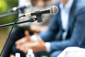 Microphone in focus at roundtable meeting or business event