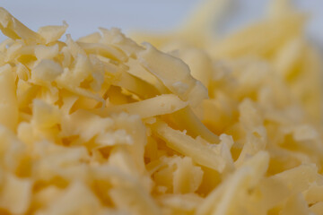Hard cheese with holes grated into thin small slices
