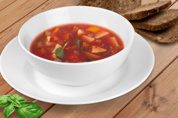 Tasty fresh soup dish in plate with bread