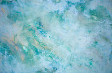 Blue background of decorative plaster with abstract spots. Unusual texture of this wall with beautiful patterns, creative surface background. Finishing coating for building cladding.