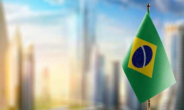 Small flags of the Brazil on an abstract blurry background