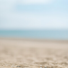 Seascape abstract beach background. blur bokeh light of calm sea and sky. Focus on sand foreground ai generative